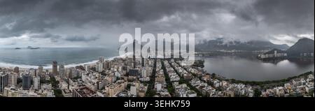 Aerial view of Ipanema beach, the urban skyline, and Rodrigo de Freitas Lagoon under dramatic storm clouds in Rio de Janeiro, State of Rio de Janeiro, Stock Photo