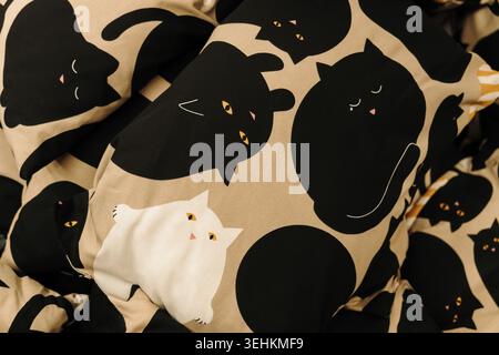 Decorative fabric with playful black and white cat illustrations. Creative textile pattern concept for modern home and children interior themes. Stock Photo