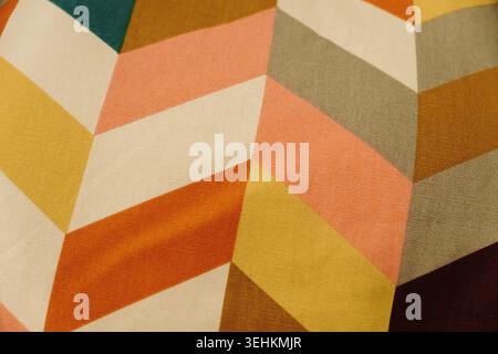 Bright geometric fabric with colorful abstract shapes and modern design. Contemporary textile background for interior and decorative concepts. Stock Photo