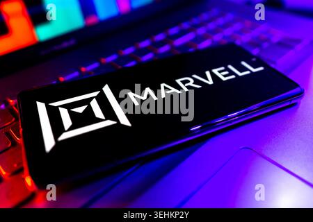 Marvell Technology Group Semiconductor Company Logo Displayed On Screen With Financial Stock Chart Performance Background Stock Photo
