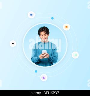 Young Man in Blue Sweater Interacting With Smartphone on Light Blue Background Stock Photo