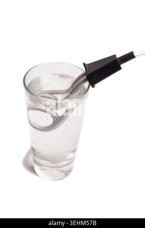 Immersion electric water heater in a glass of water isolated on white background Stock Photo