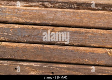 This is a texture of aged, rustic wooden planks with a dark brown, weathered grain Stock Photo