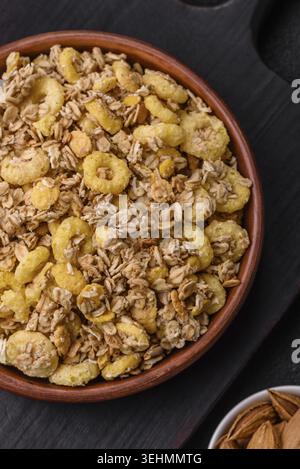 Food, Flakes, chocolate balls and dried fruit for a hearty breakfast. Granola with chocolate flakes Stock Photo