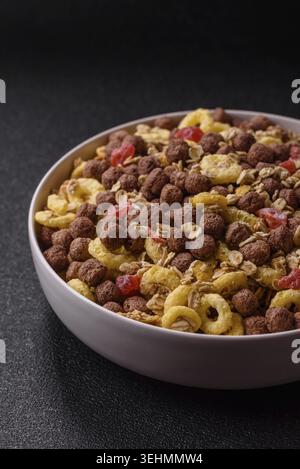 Food, Flakes, chocolate balls and dried fruit for a hearty breakfast. Granola with chocolate flakes Stock Photo