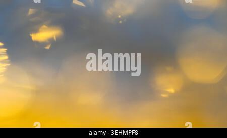Soft golden bokeh circles blend with deep blue tones for a festive dreamy effect. Stock Photo