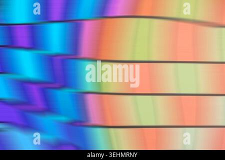A vibrant abstract background featuring a dynamic blend of flowing multicolored lines in a geometric pattern. The soft hues create a sense of movement Stock Photo