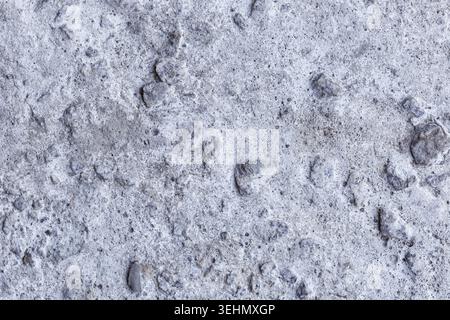 Grunge background texture featuring a concrete wall in grey color. The surface exhibits distinct old grunge textures with visible scratches and cracks Stock Photo