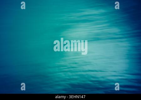 Abstract teal and blue motion blur background with soft white highlights, smooth gradient flow, and watery streak texture, ideal for modern design, ba Stock Photo
