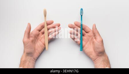 Hands with two toothbrushes on white background Stock Photo