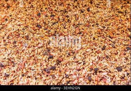 Close-up macro of a mixed dried spice blend with seeds, herbs, and chili flakes, forming a warm textured background for cooking, seasoning, and food d Stock Photo