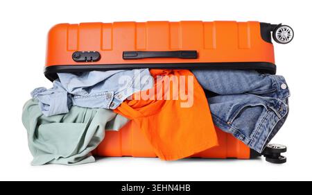 Packed suitcase with messy clothes isolated on white Stock Photo