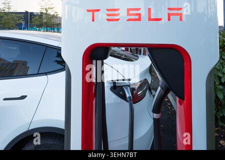 Tesla Supercharger station with an electric vehicle charging. London, UK, 14 October 2023 Stock Photo