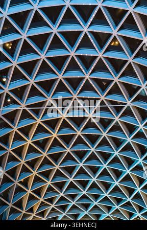 Futuristic symmetry architectural abstract modern blue building with triangular ceiling pattern and led lighting Stock Photo