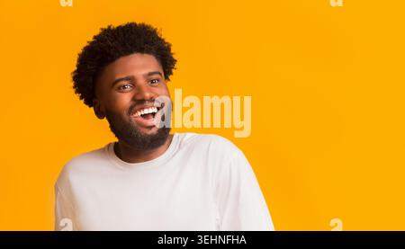 Excited happy black guy looking at empty space Stock Photo