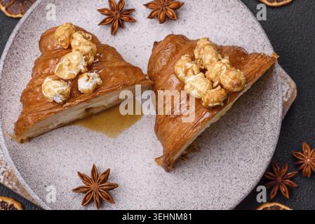 Food, Sweet crispy croissant with salted caramel and glazed popcorn on a dark textured background Stock Photo