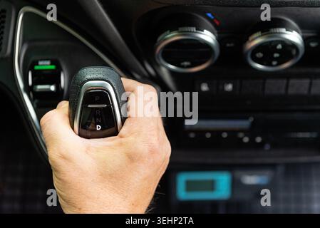 Close up of a man finger pressing an electronic start stop button or control in vehicle Stock Photo