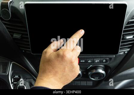 Man touching empty black display of modern car multimedia system with index finger close up Stock Photo