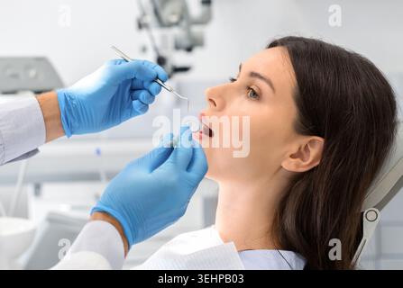 Close up of young woman looking at dentist with confidence Stock Photo