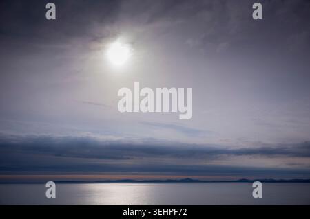Sun setting over Mawddach Estuary at Barmouth in North Wales, UK Stock Photo
