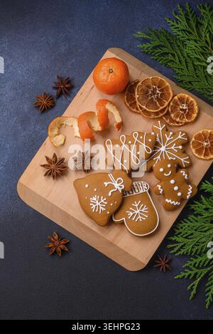Food, Beautiful festive Christmas composition of tangerines, gingerbread and star anise on a dark textured background Stock Photo