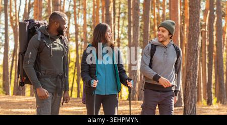 Cheerful friends backpacking at countryside, enjoying active weekend Stock Photo