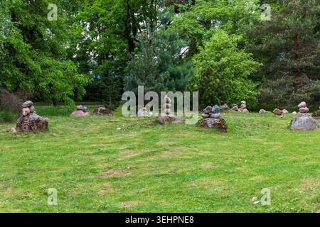 Balanced Stone Cairns on Large Boulders in Zen Park Forest Clearing Stock Photo