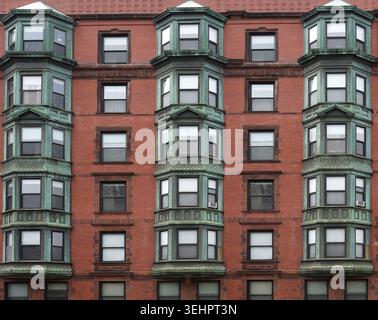 old apartment building with blue-green bay windows Stock Photo