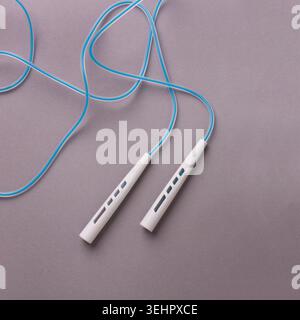 Jumping or skipping rope on gray background Stock Photo