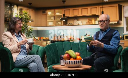 Glasses for reading, checking dosage, pills box label, prescription medicine, senior man using spectacles to read important administration information on package. Medicine for longevity. Stock Photo