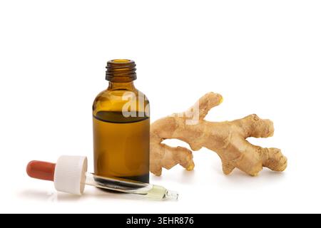 Ginger root essential oil in amber glass dropper bottle isolated on white background. Natural herbal extract for aromatherapy, skincare, wellness, cos Stock Photo
