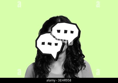 Person Engaged in Conversation With Speech Bubbles on a Green Background Stock Photo