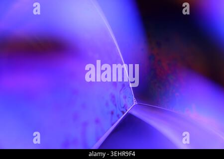 Abstract Macro Shot of Geometric Liquid Planes and Glowing Purple Light Stock Photo