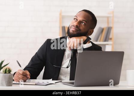 Dreamy entrepreneur thinking about his company future Stock Photo