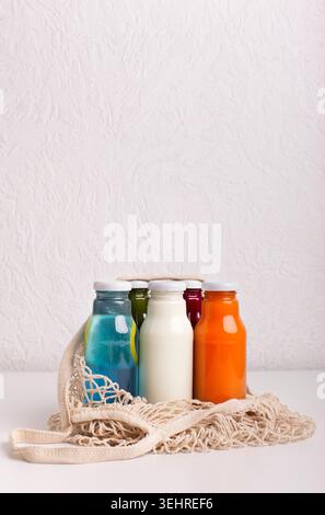 Different detox cocktails in glass bottles on gray background Stock Photo