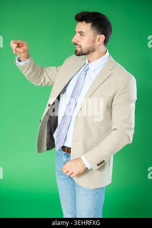 Adult man using virtual screen in front of green screen Stock Photo