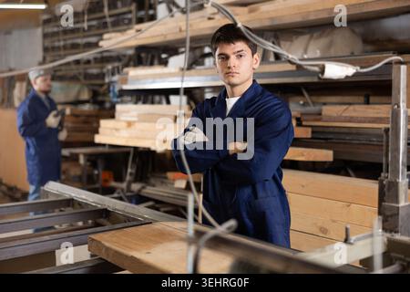 Portrait of young positive worker of furniture factory in production workshop Stock Photo