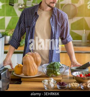 Unrecognizable young man preparing vegetables for cooking Stock Photo