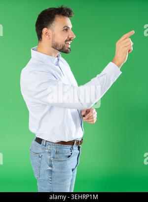 Adult man using virtual screen in front of green screen Stock Photo