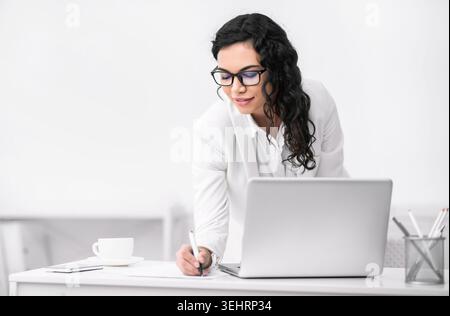 Mexican woman taking down some notes and ideas Stock Photo