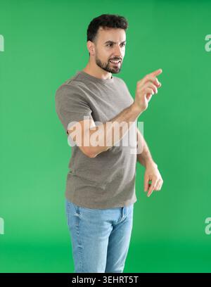 Adult man using virtual screen in front of green screen Stock Photo