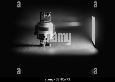 Macro shot of a robot figurine near a spotlight toys, background, collectible Stock Photo