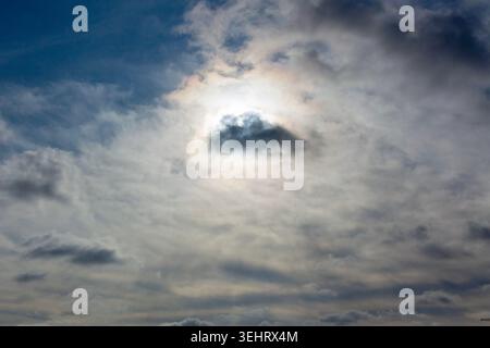 Sun is shining from behind the clouds Stock Photo
