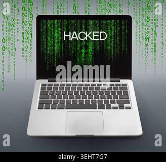 Laptop with hacked message and binary code numbers on screen Stock Photo
