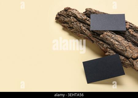Tree bark with black blank business cards on yellow background Stock Photo