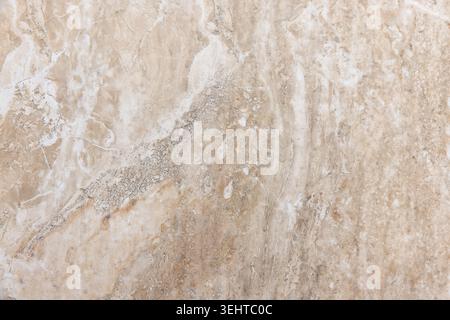 Beige marble surface with subtle veins and organic mineral patterns, ideal as a textured background for design, interior visuals, architecture project Stock Photo