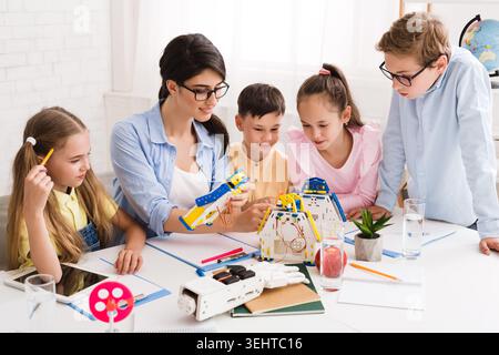 Engaging Classroom Activity With Students Exploring Robotics and Creativity in a Bright Space Stock Photo