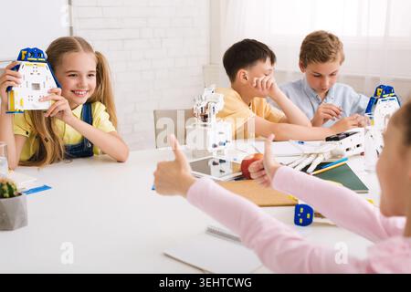 Children Engage in Creative Building Activity During a Collaborative Session in a Bright Classroom Stock Photo