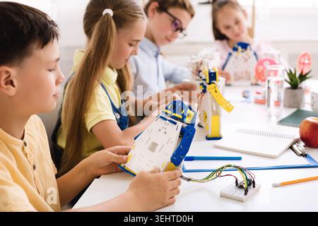 Students Engage in Robotics Workshop While Building Robot Models Stock Photo