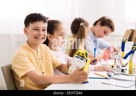 Children Engaged in Robotics Activity at a Classroom Workshop Focusing on Creativity and Teamwork Stock Photo